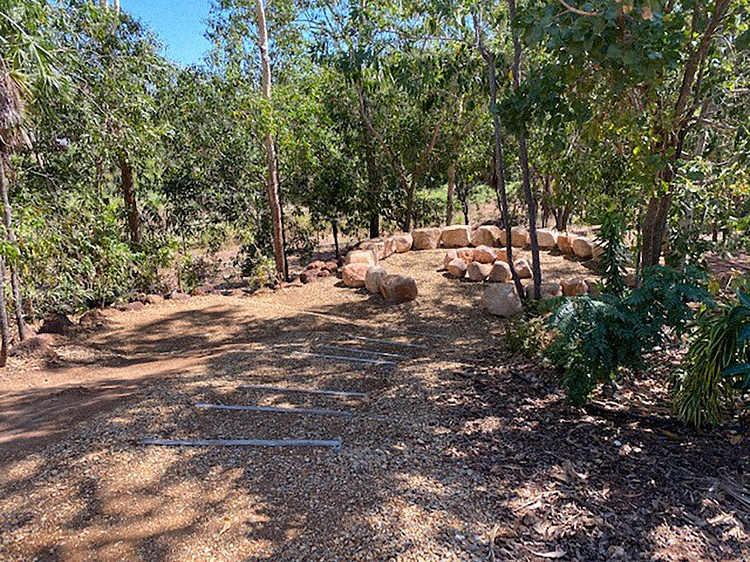 The Sunrise Centre showing an outdoor reflection area under trees