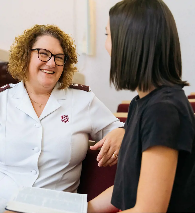 A young woman chats with a Salvos officer.