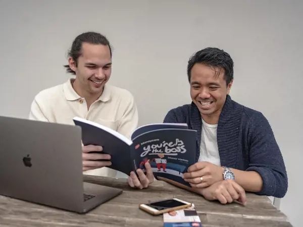 A young man is introduced to some new strategies via the 'You're the Boss' booklet.