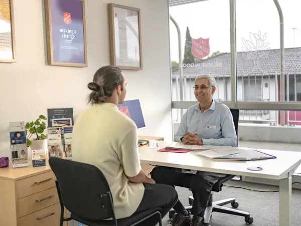 A Moneycare financial counsellor and their client.