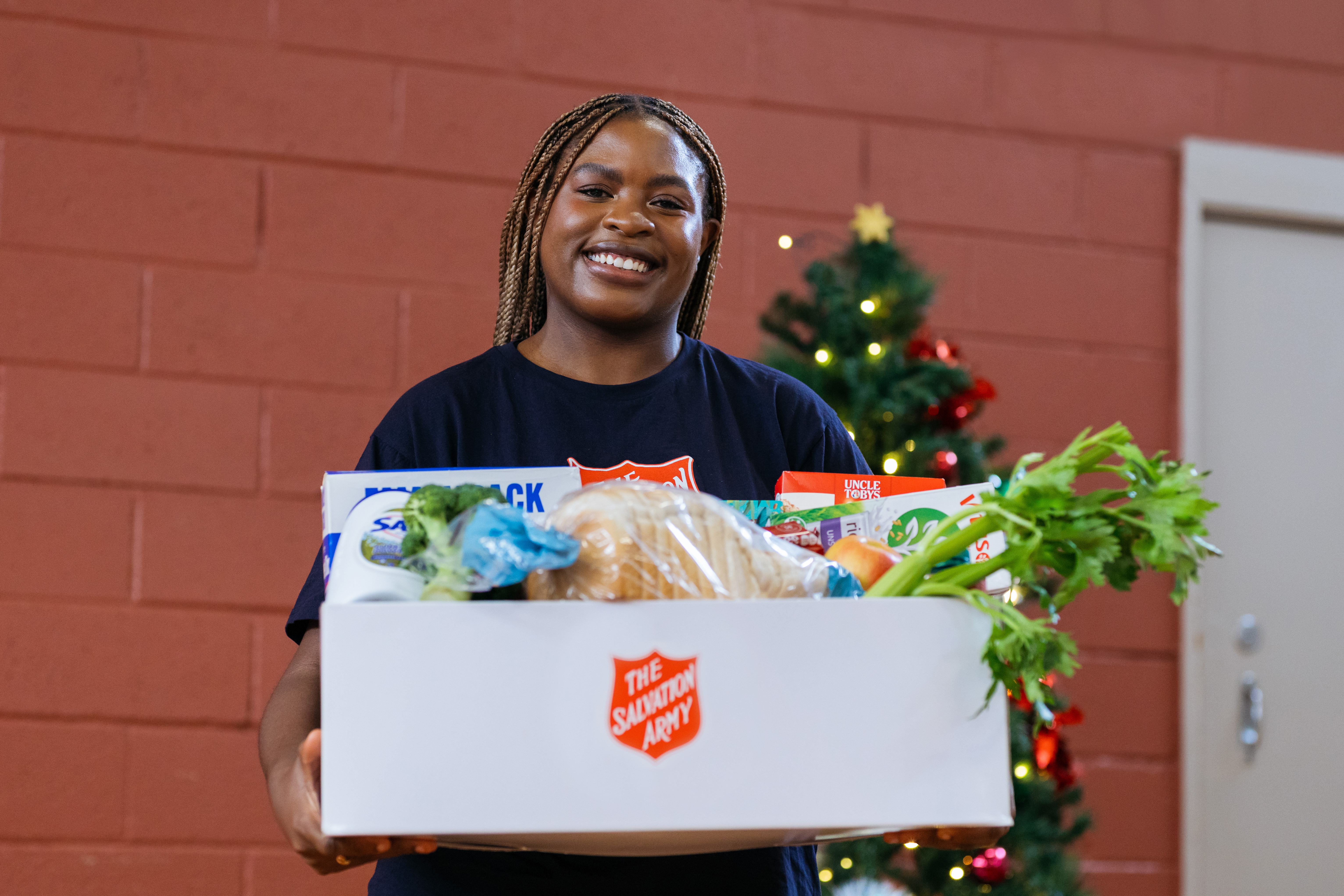 Woman holding a box of donated food