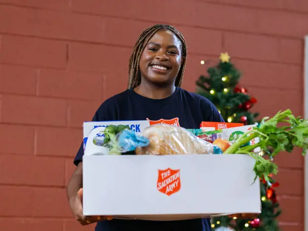 Woman holding a box of donated food