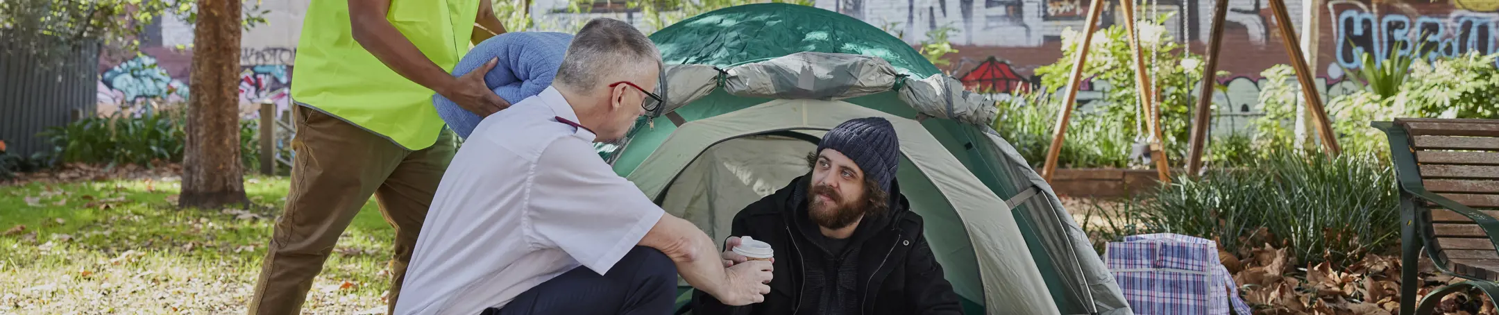 Salvos helping someone experiencing homelessness and living in a tent