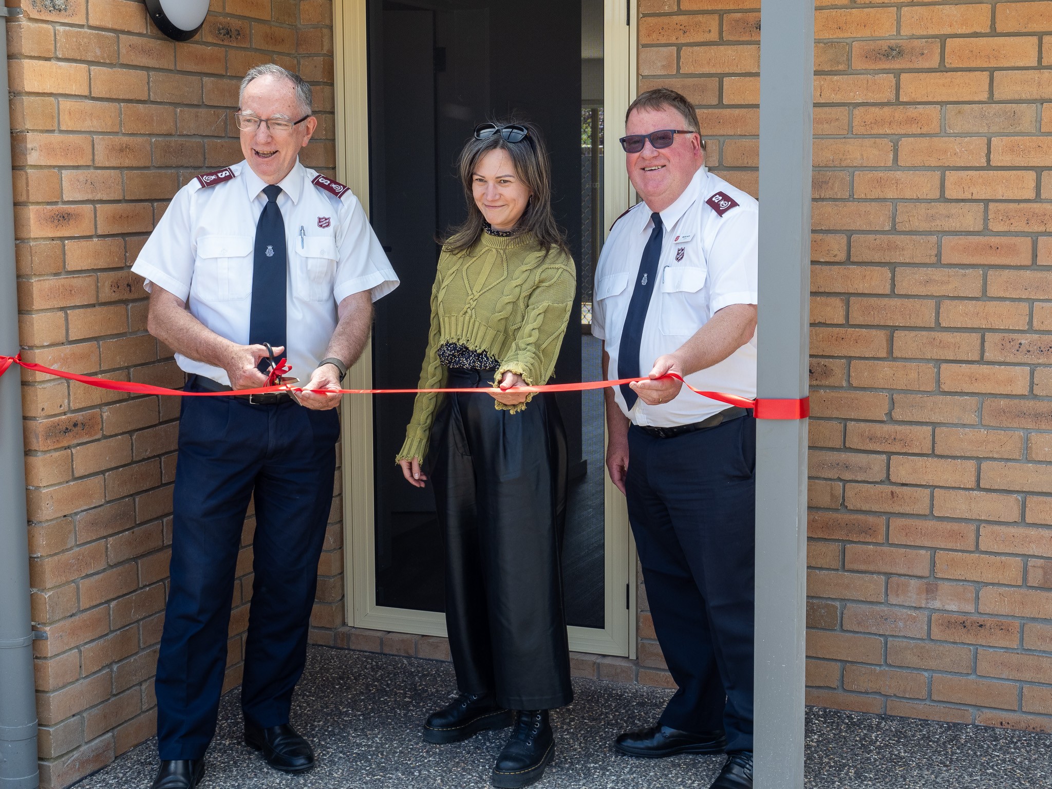 Salvos officer cutting a ribbon