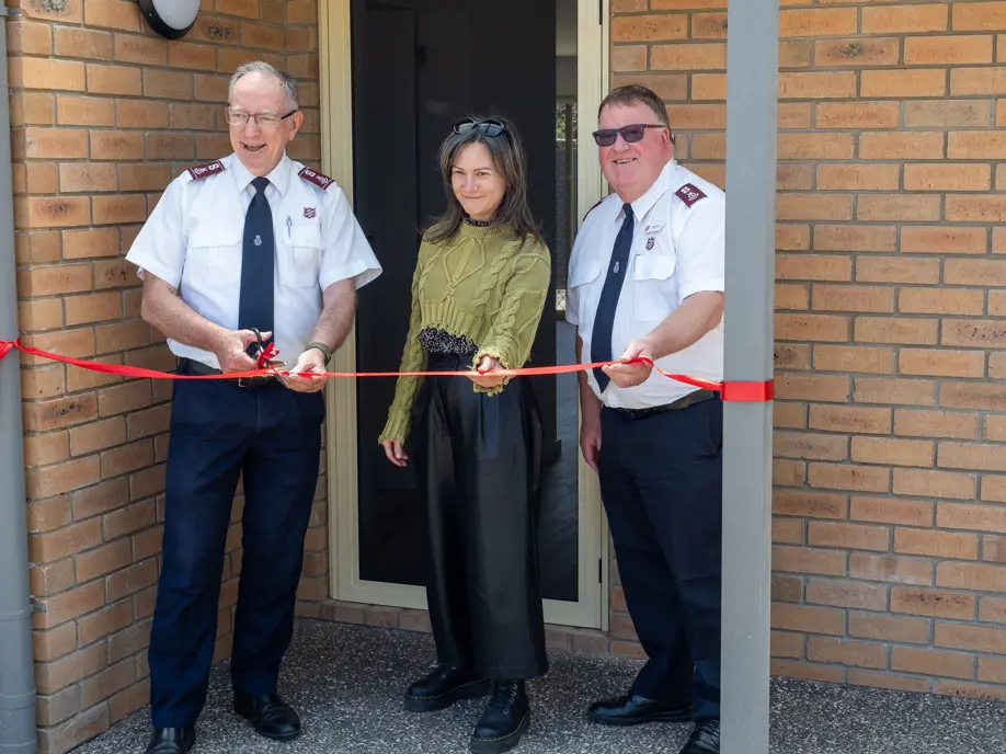 Salvos officer cutting a ribbon