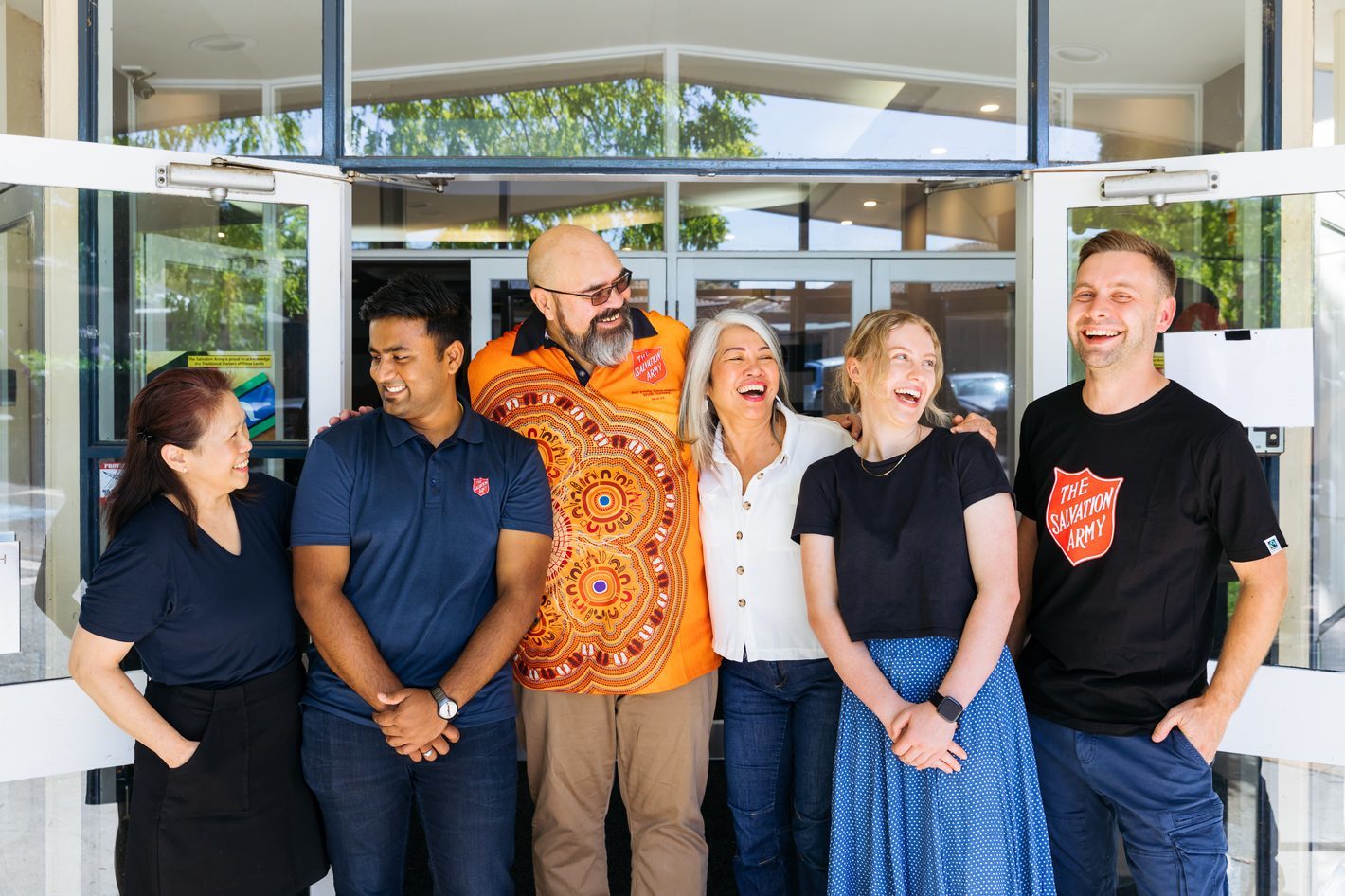 group of Salvation Army people smiling outside building